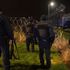 Migrants scramble to climb on UK-bound lorries as they try to evade police in Calais